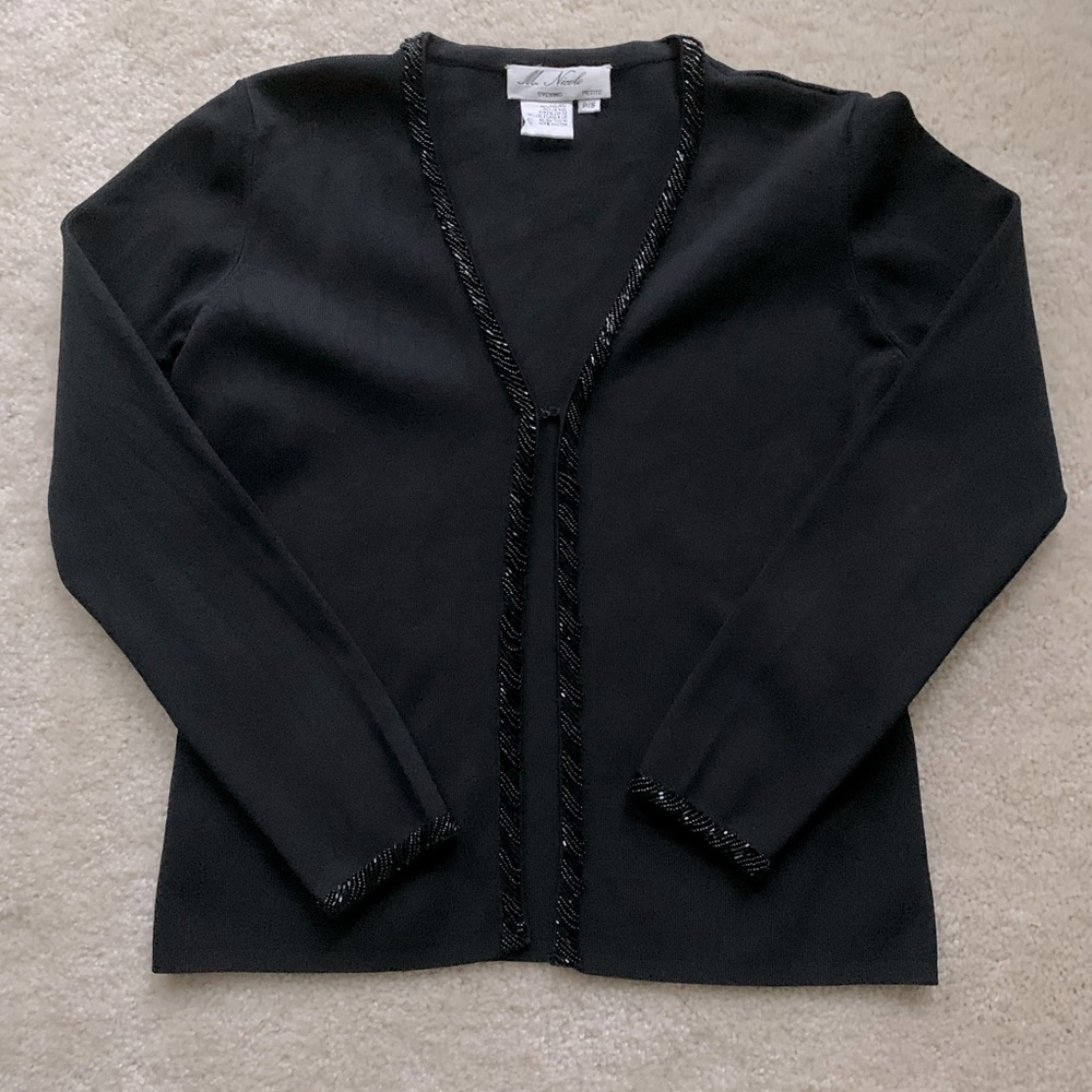 Sweater with sequins on front and cuffs.